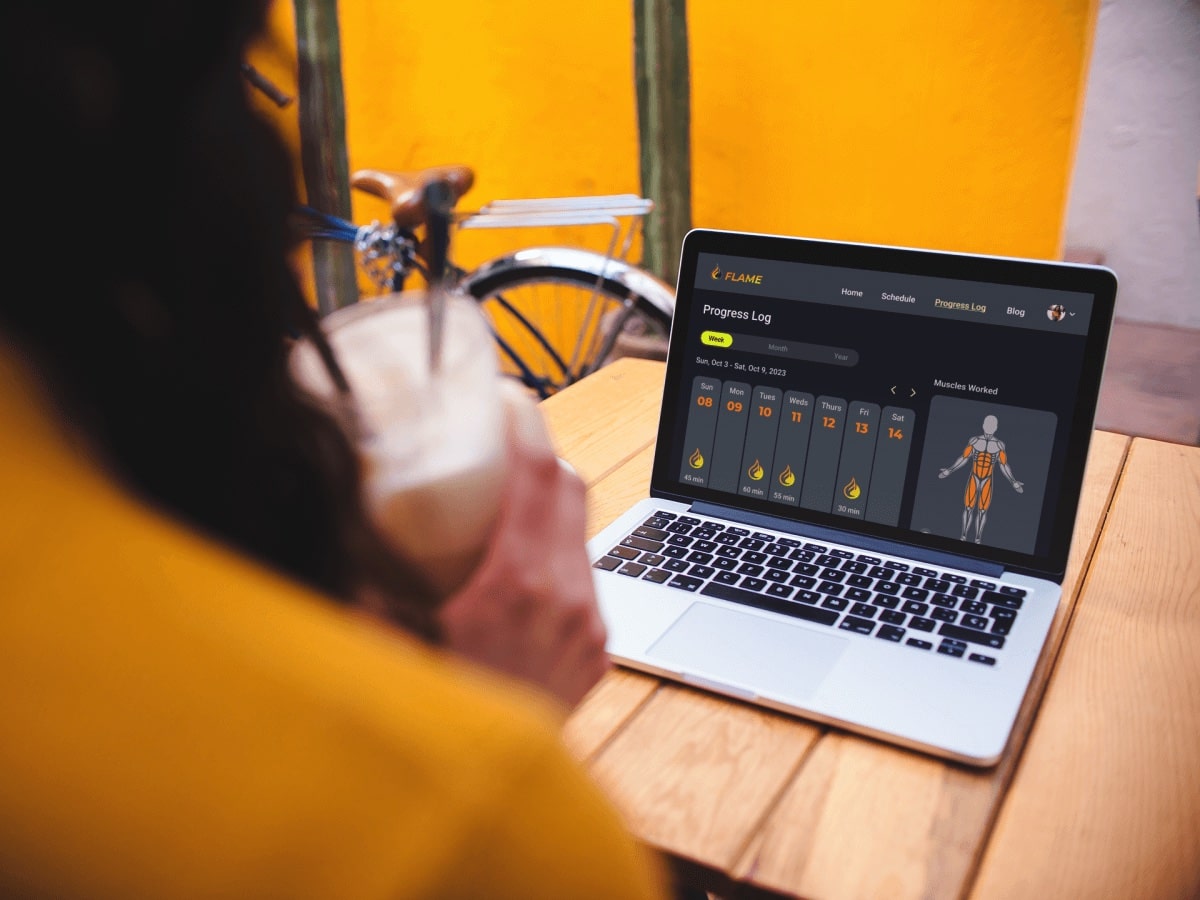 Presentation mockup photo showing woman looking at laptop showing the progress log screen.